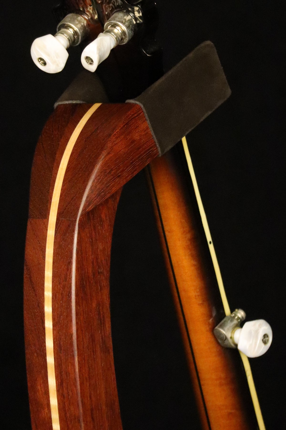 Folding bubinga rosewood and curly maple wood banjo floor stand yoke detail image with Alvarez banjo