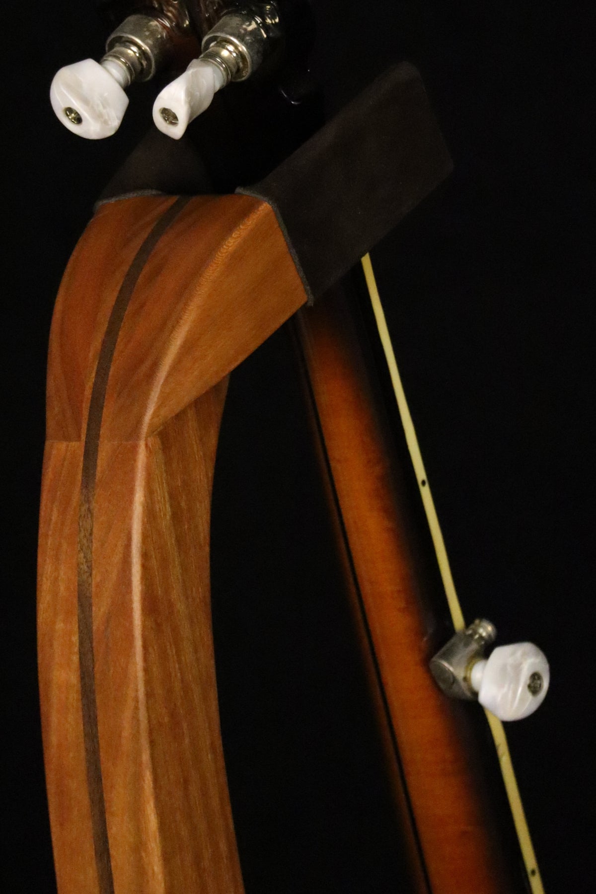 Folding cherry and walnut wood banjo floor stand yoke detail image with Alvarez banjo