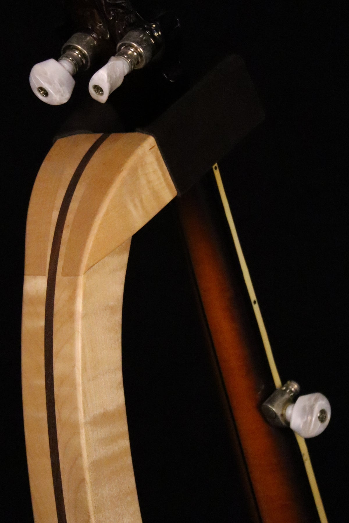Folding curly maple and walnut wood banjo floor stand yoke detail image with Alvarez banjo