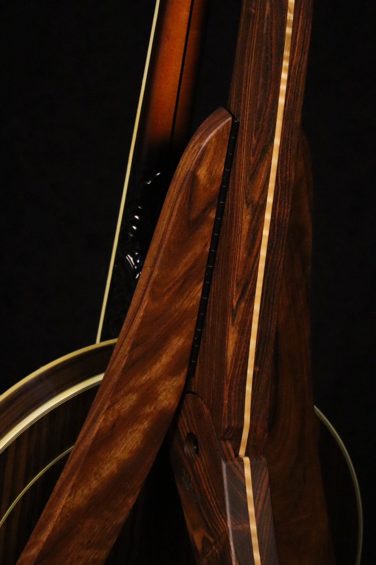 Folding chechen Caribbean rosewood and curly maple wood banjo floor stand closeup rear image with Alvarez banjo