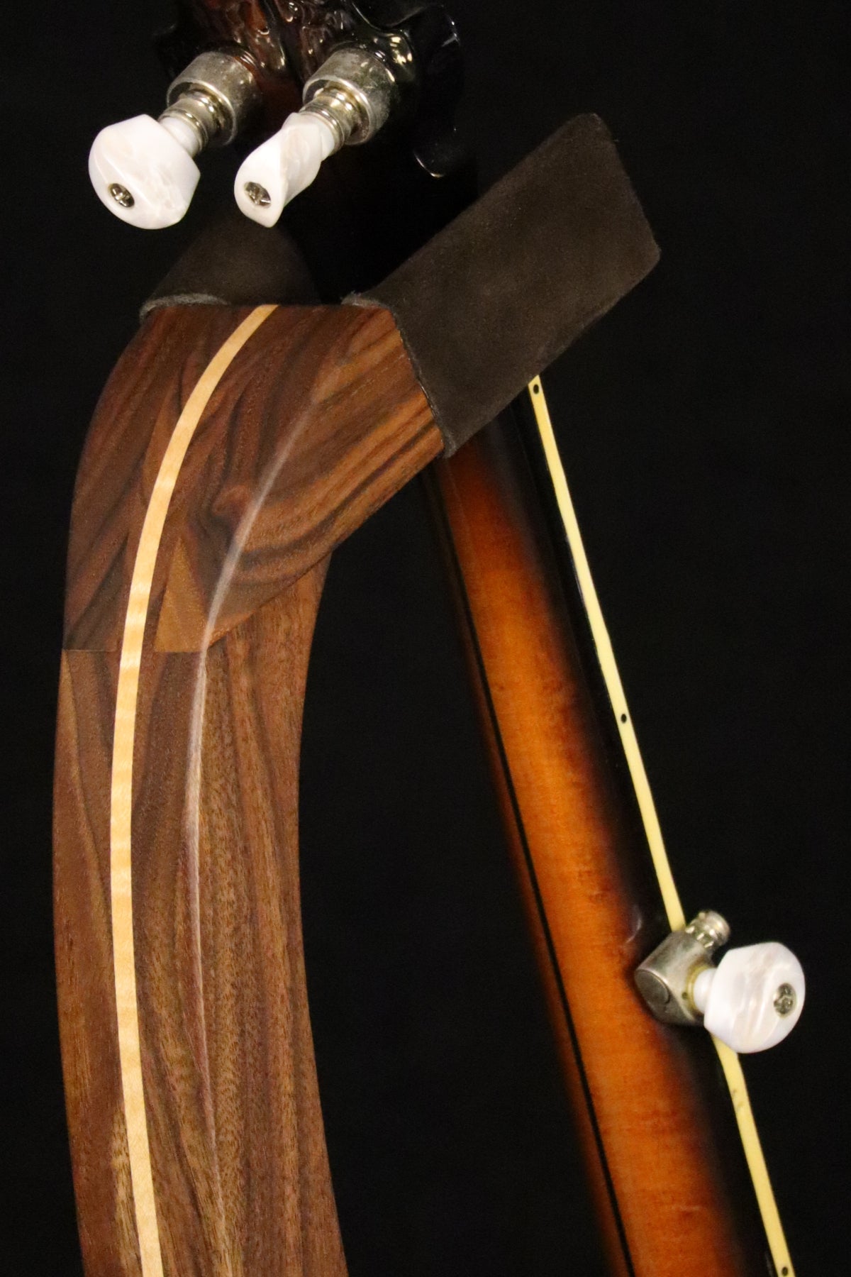 Folding walnut and curly maple wood banjo floor stand yoke detail image with Alvarez banjo