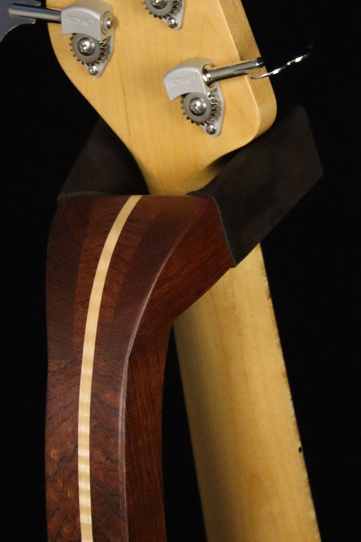 Folding bubinga rosewood and curly maple wood electric bass guitar floor stand closeup yoke detail image
