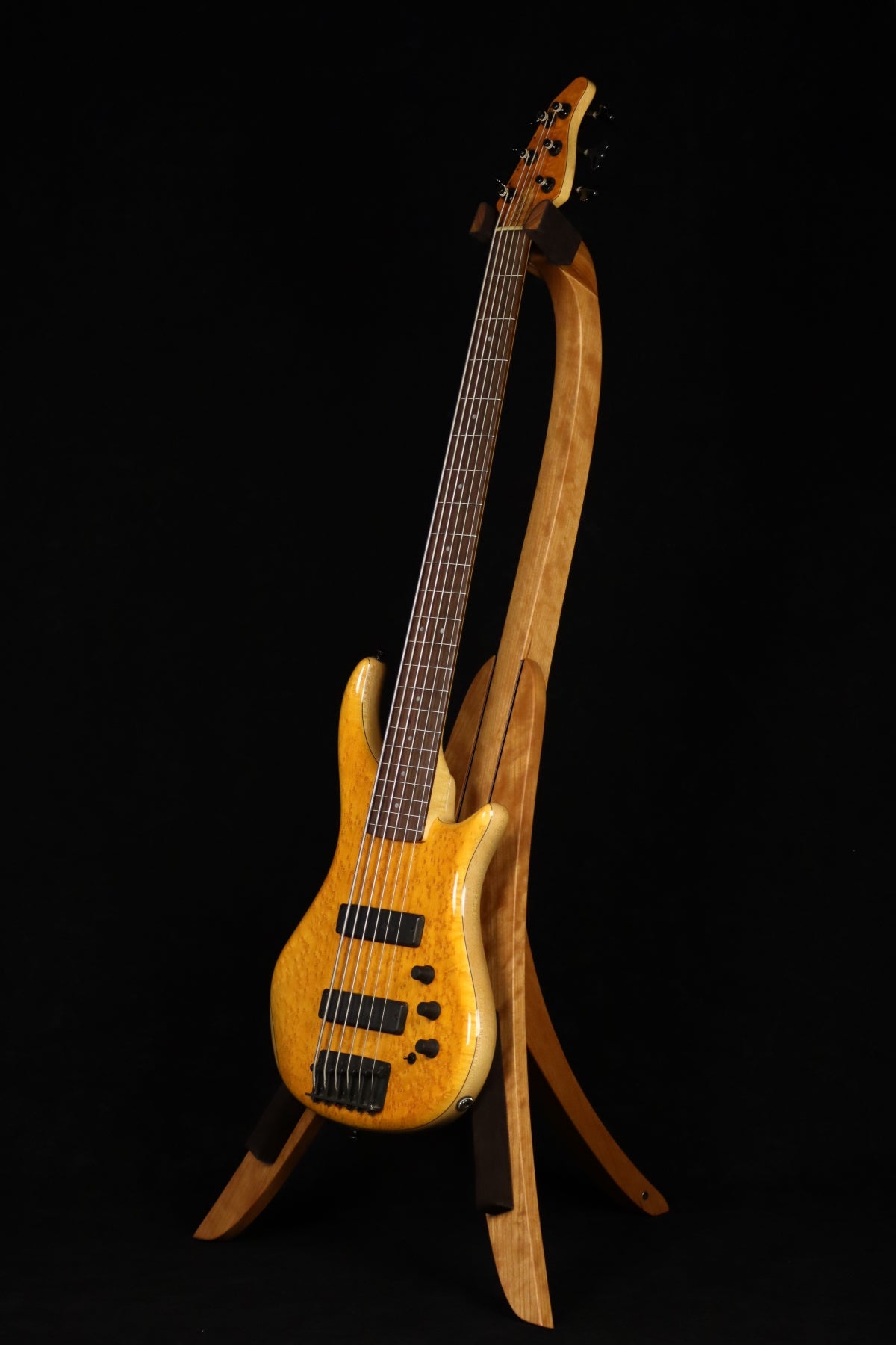 Folding cherry wood electric bass guitar floor stand full front image with Pedulla 6 string fretless bass