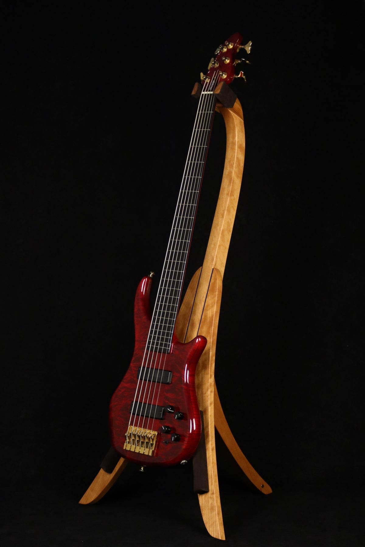 Folding cherry wood electric bass guitar floor stand full front image with Pedulla 6 string fretless bass