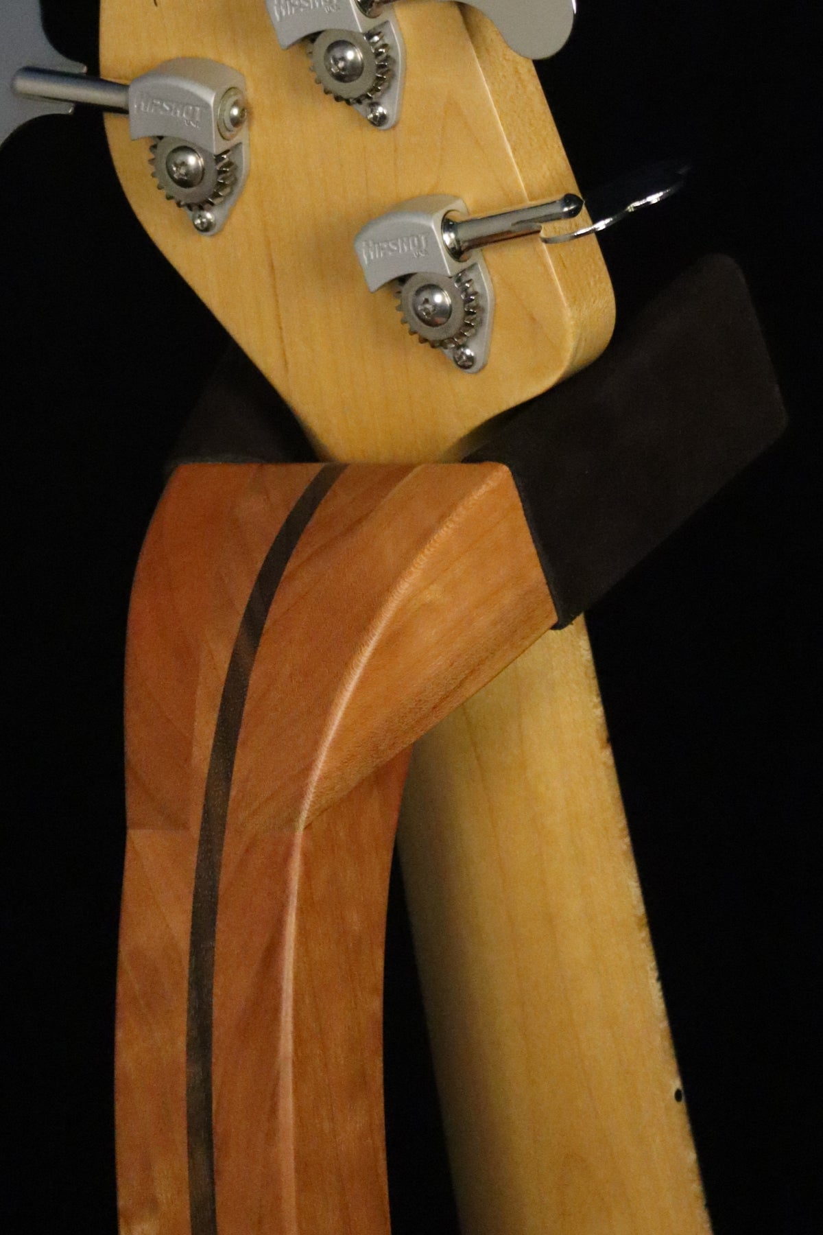 Folding cherry and walnut wood electric bass guitar floor stand closeup yoke detail image