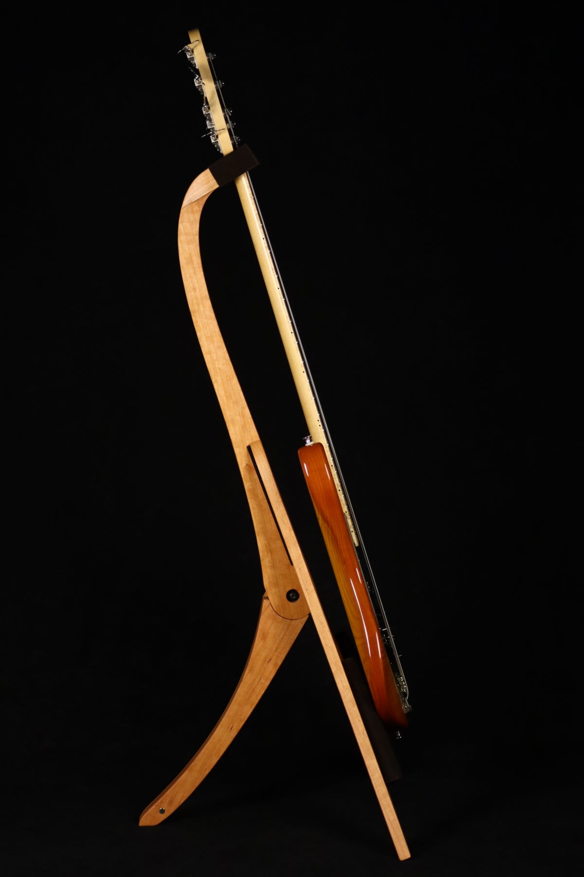 Folding cherry and walnut wood electric bass guitar floor stand full side image with Sadowsky 5 string bass