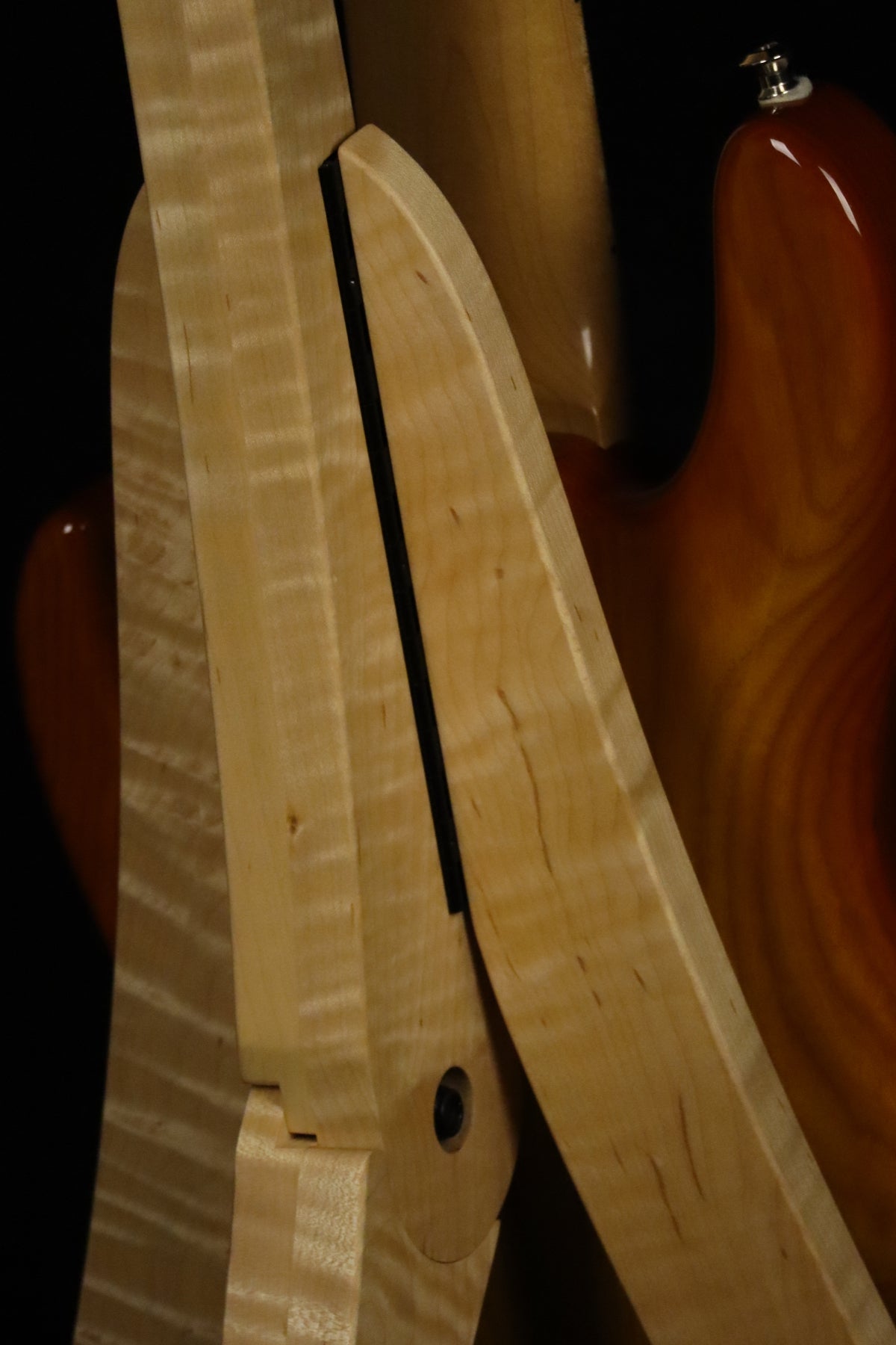 Folding curly maple wood electric bass guitar floor stand closeup rear image