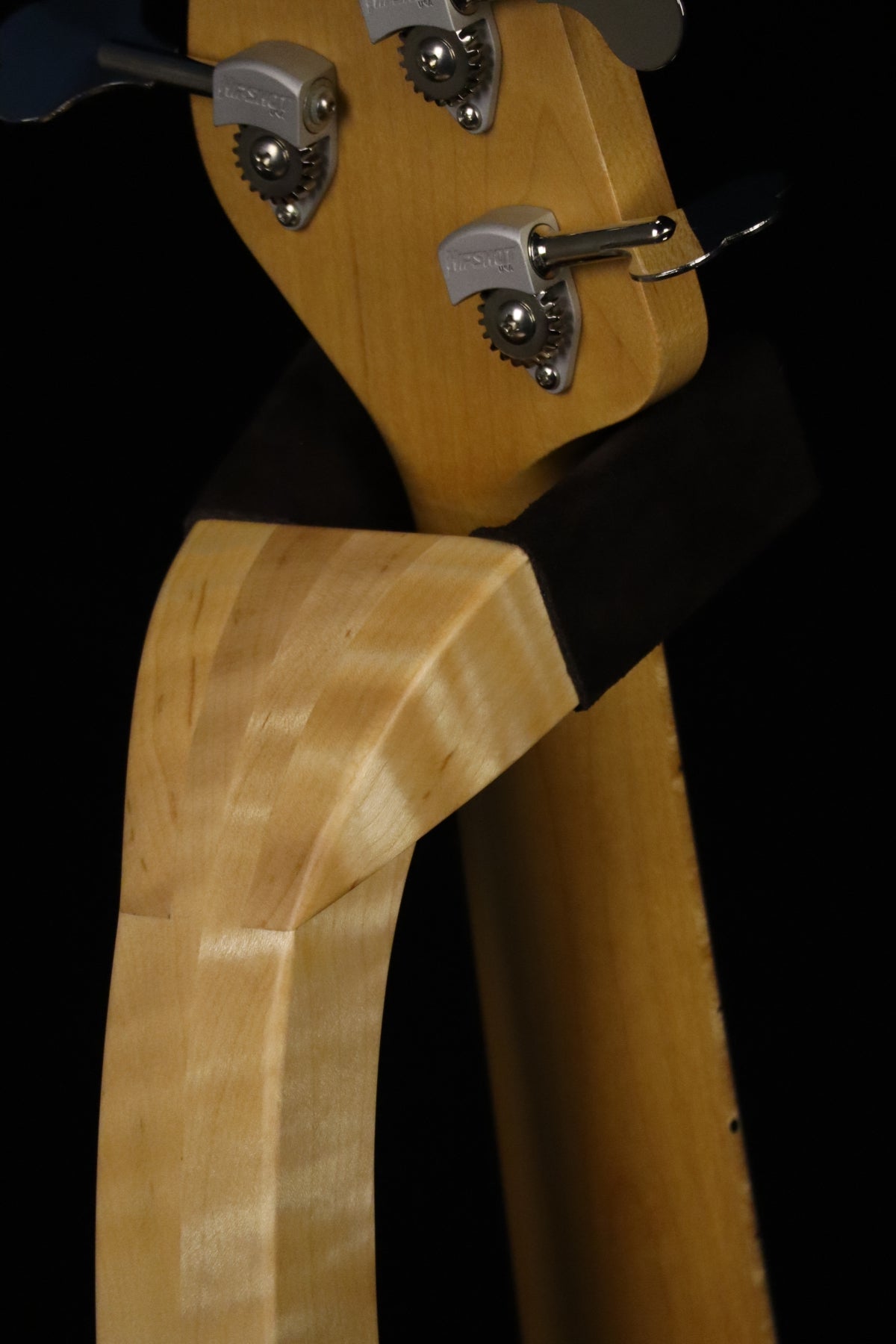 Folding curly maple wood electric bass guitar floor stand closeup rear yoke detail image