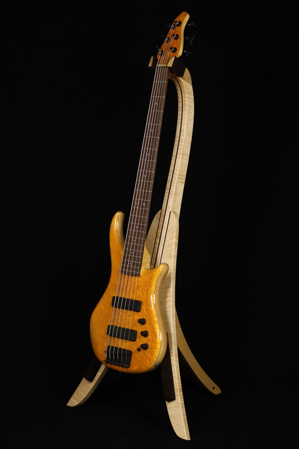 Folding curly maple and walnut wood electric bass guitar floor stand full front image with Pedulla 6 string fretless bass