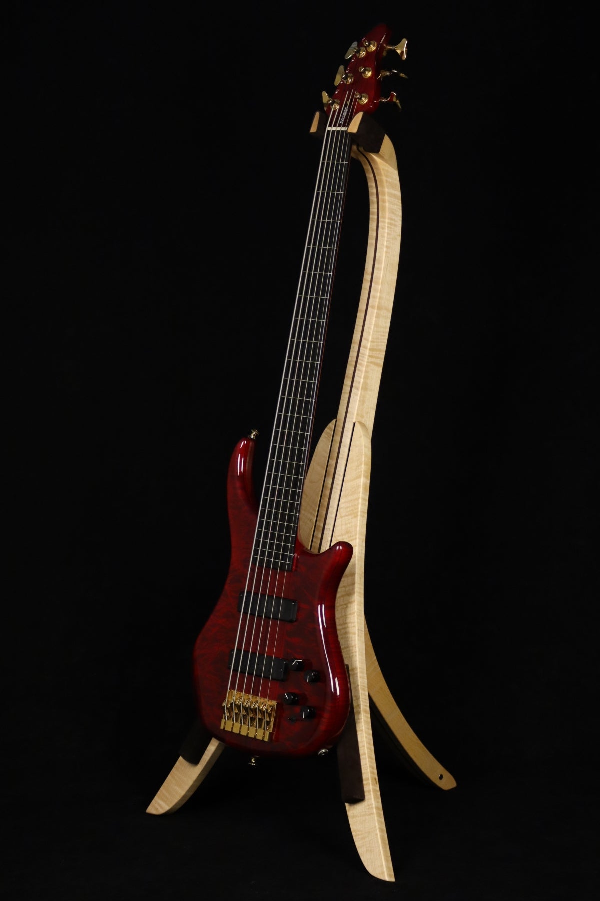 Folding curly maple and walnut wood electric bass guitar floor stand full front image with Pedulla 6 string fretless bass