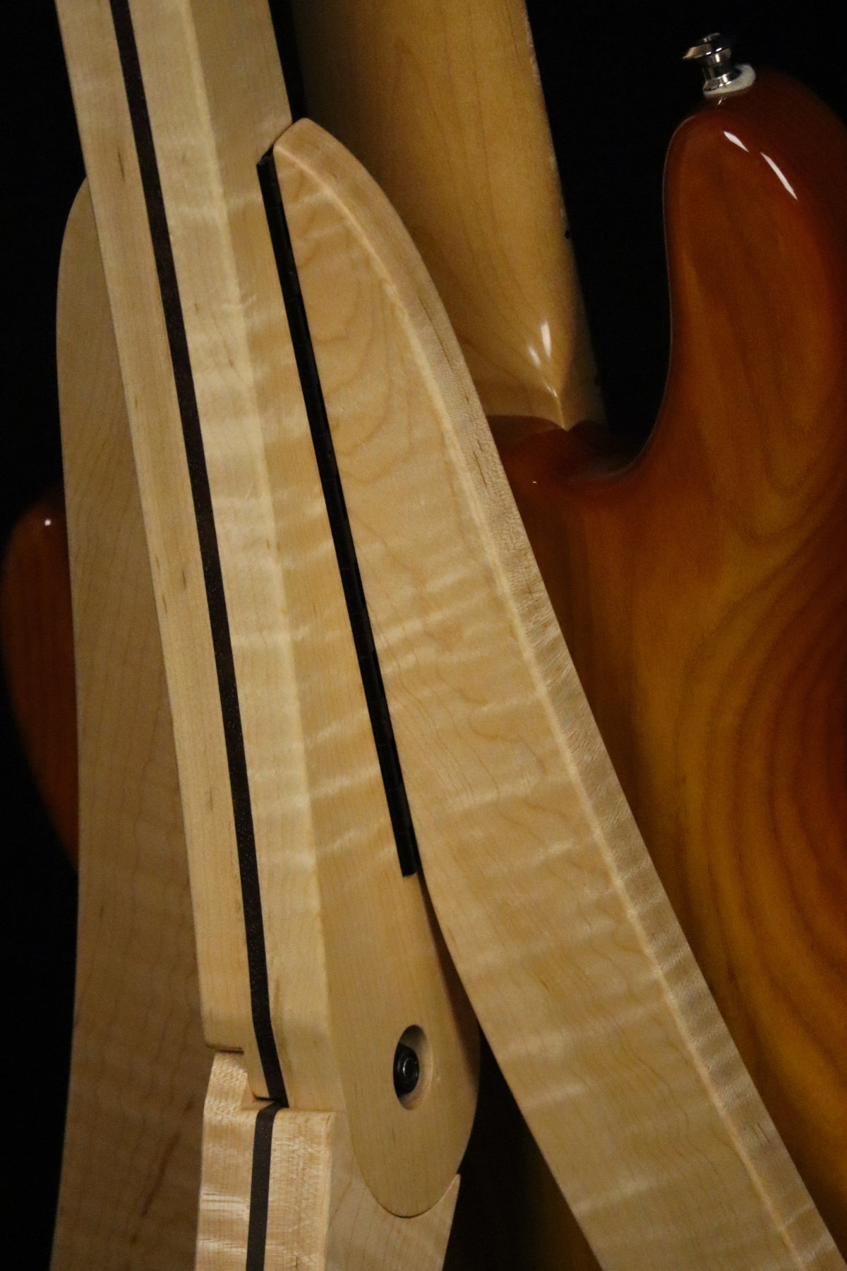 Folding curly maple and walnut wood electric bass guitar floor stand closeup rear image