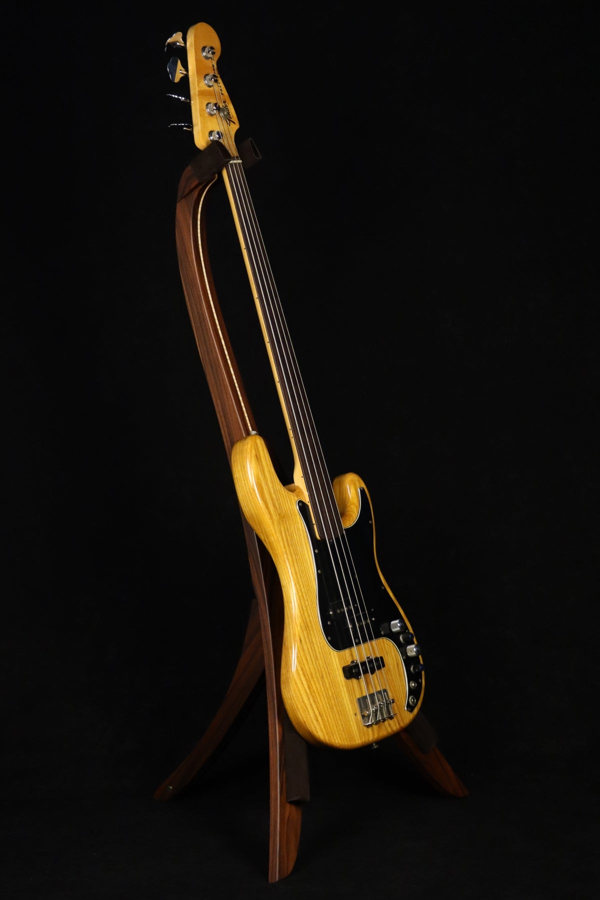 Folding morado Bolivian rosewood and curly maple wood electric bass guitar floor stand full front image with Fender 4 string fretless bass