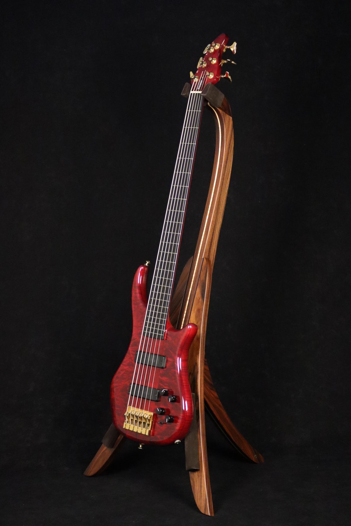 Folding morado Bolivian rosewood and curly maple wood electric bass guitar floor stand full front image with Pedulla 6 string fretless bass