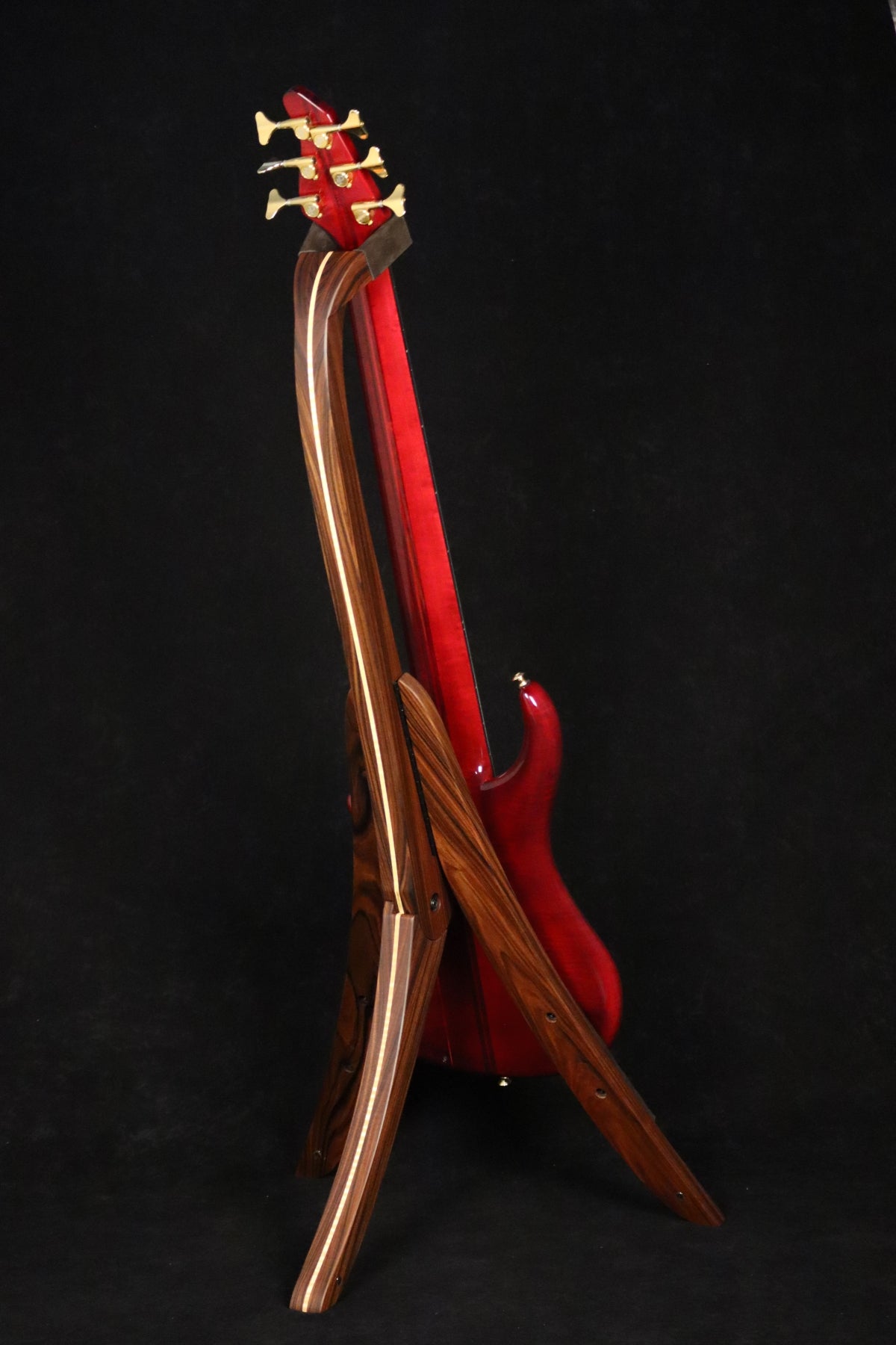 Folding morado Bolivian rosewood and curly maple wood electric bass guitar floor stand full rear image with Pedulla 6 string fretless bass