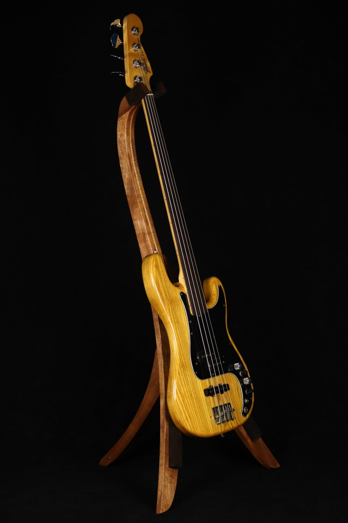 Folding sapele mahogany and curly maple wood electric bass guitar floor stand full front image with Fender 4 string fretless bass