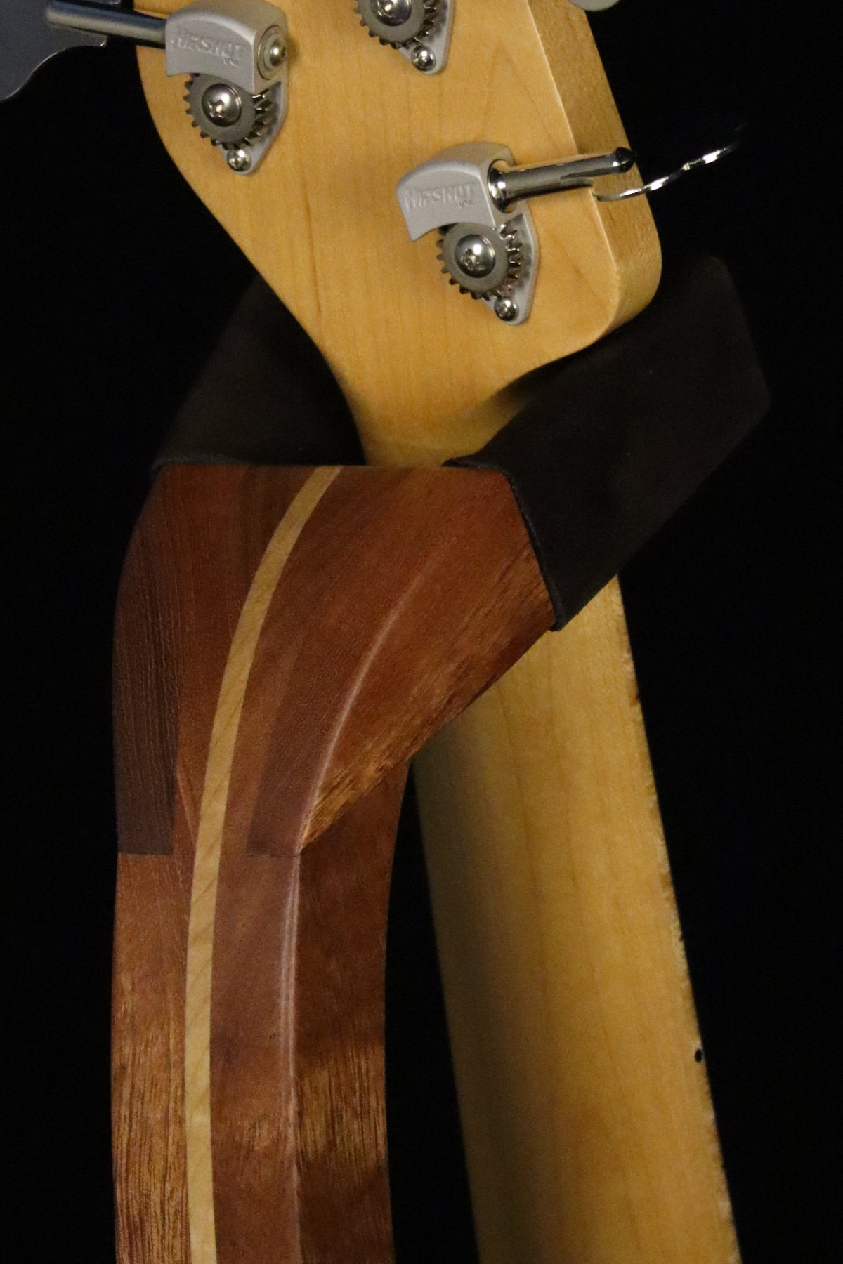 Folding sapele mahogany and curly maple wood electric bass guitar floor stand closeup yoke detail image