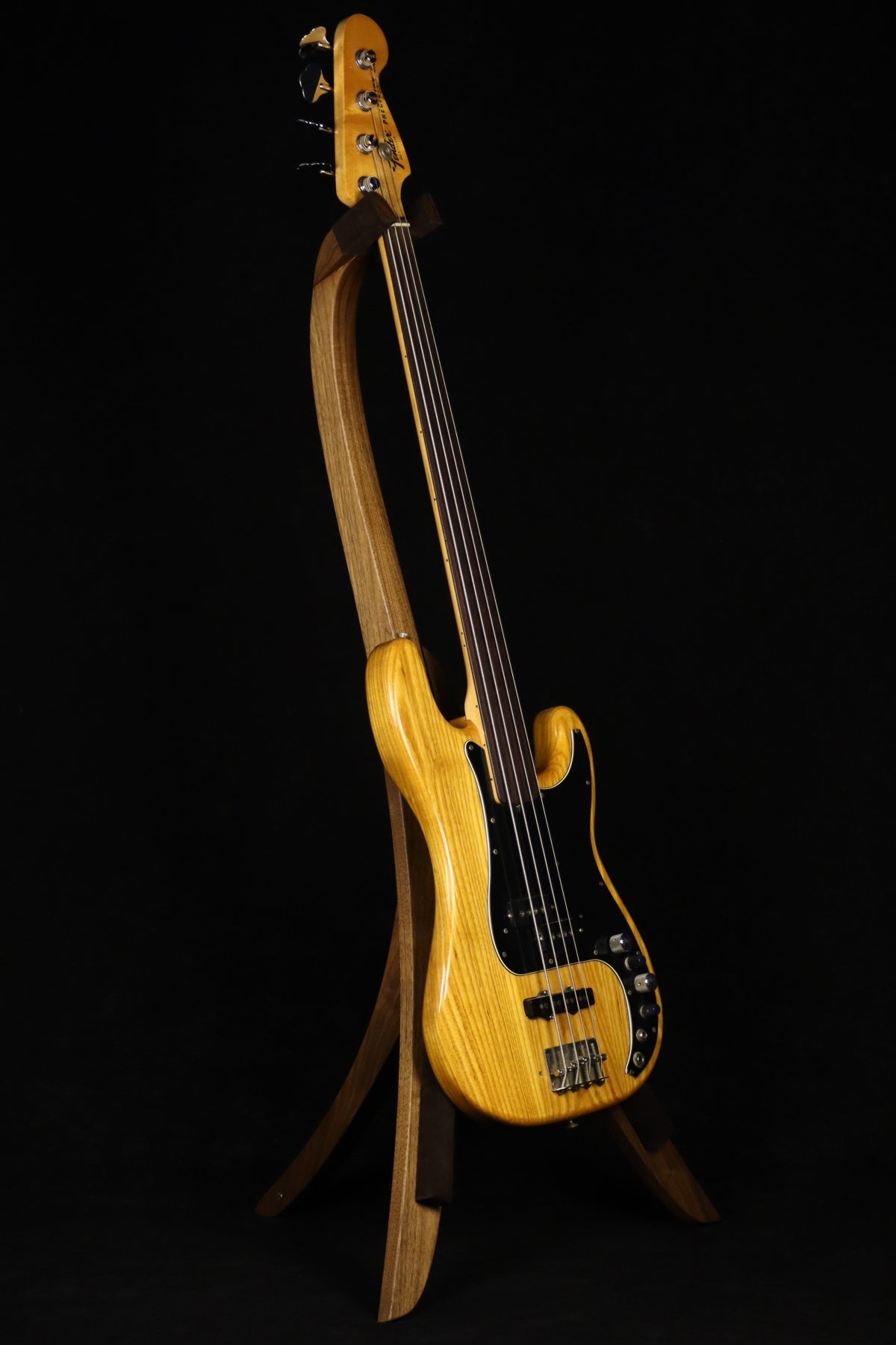 Folding walnut wood electric bass guitar floor stand full front image with Fender Precision 4 string fretless bass