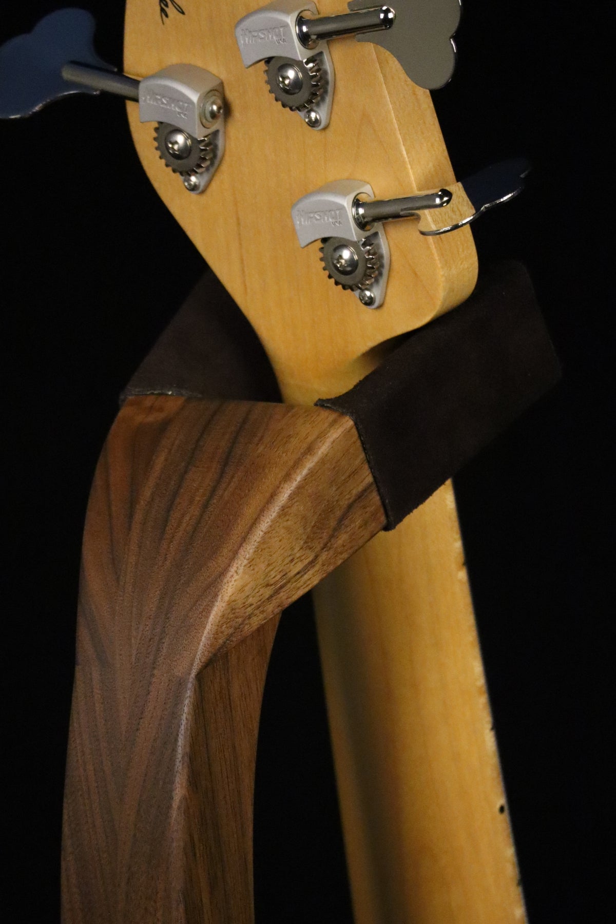 Folding walnut wood electric bass guitar floor stand closeup rear yoke detail image