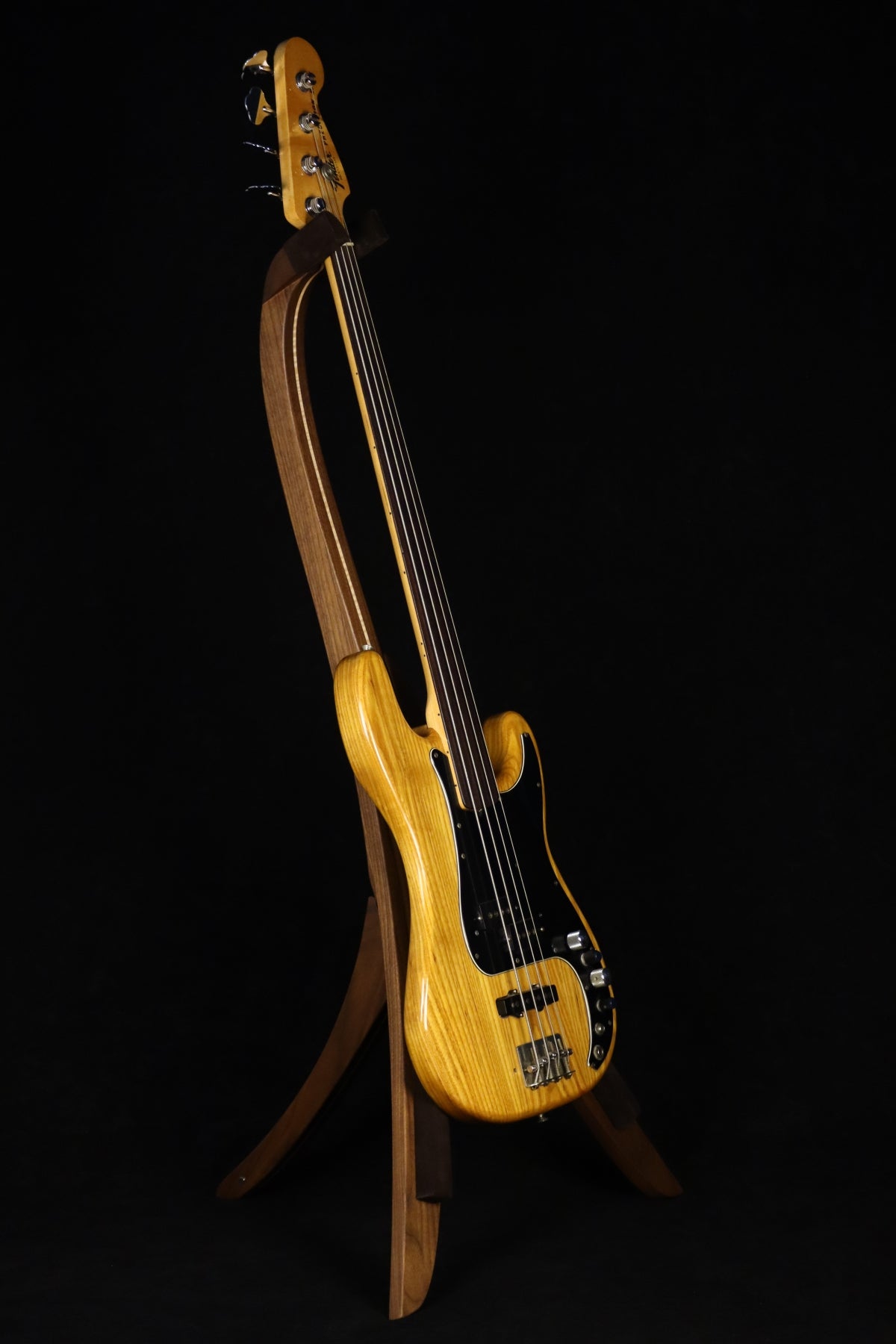 Folding walnut and curly maple wood electric bass guitar floor stand full front image with Fender 4 string fretless bass