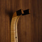Curly maple and walnut wood guitar wall mount hanger installed on paneled wall