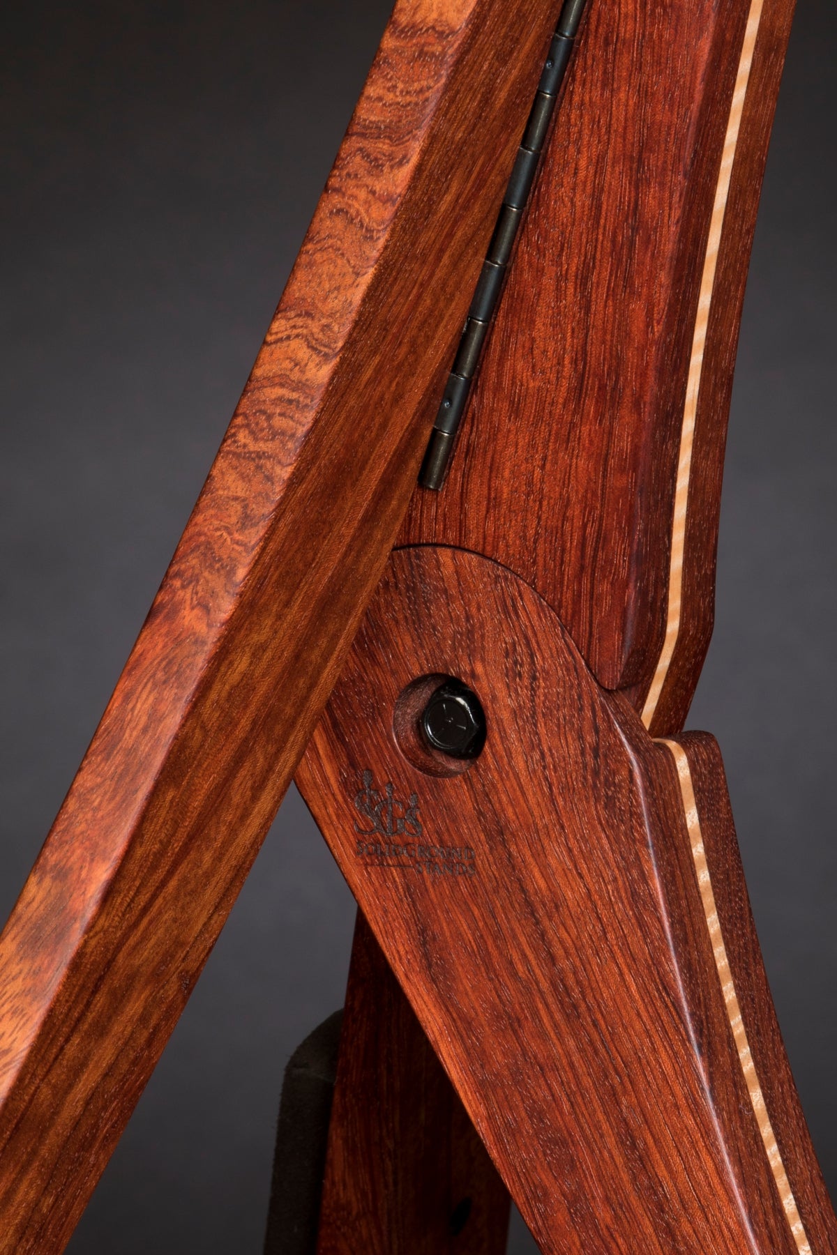 Folding bubinga rosewood and curly maple wood guitar floor stand joinery detail image