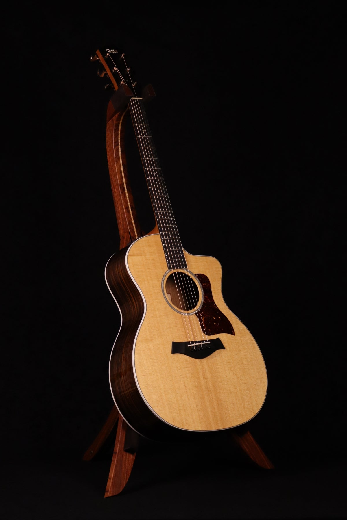 Folding bubinga rosewood and curly maple wood guitar floor stand full front image with Taylor guitar