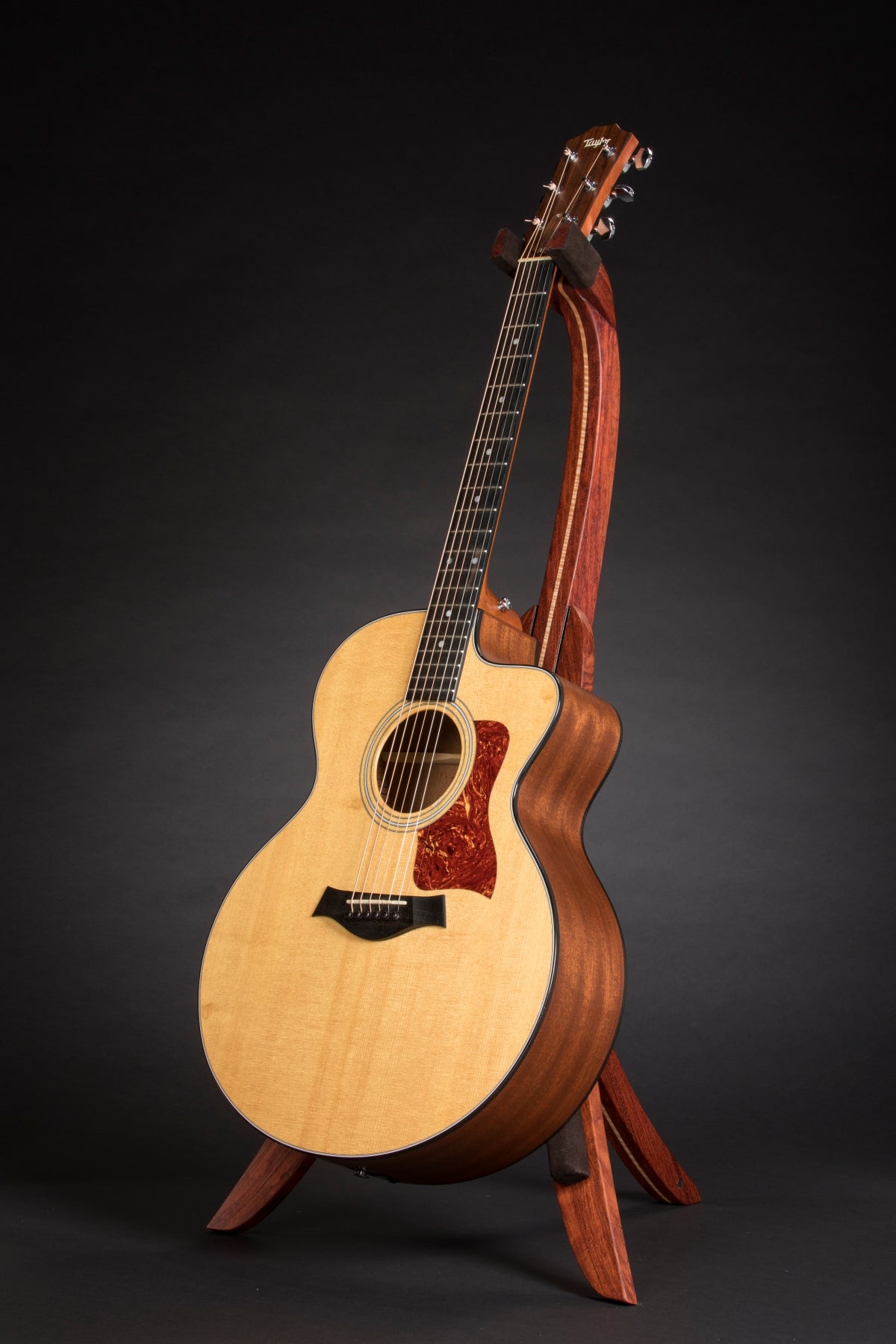 Folding bubinga rosewood and curly maple wood guitar floor stand full front image with Taylor guitar