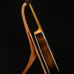 Folding bubinga rosewood and curly maple wood guitar floor stand full side image with Taylor guitar