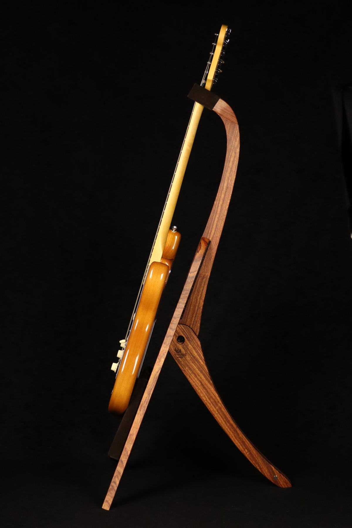 Folding bubinga rosewood and curly maple wood guitar floor stand full side image with Fender guitar