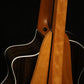 Folding cherry wood guitar floor stand closeup rear image with Taylor guitar