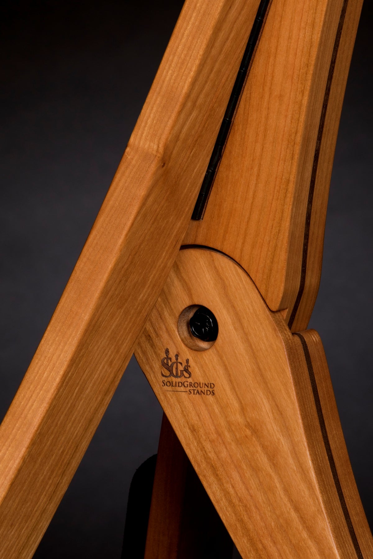 Folding cherry and walnut wood guitar floor stand joinery detail image
