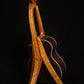 Folding cherry and walnut wood guitar floor stand full rear image with Taylor guitar