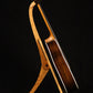 Folding cherry and walnut wood guitar floor stand full side image with Taylor guitar