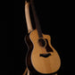 Folding curly maple wood guitar floor stand full front image with Taylor guitar