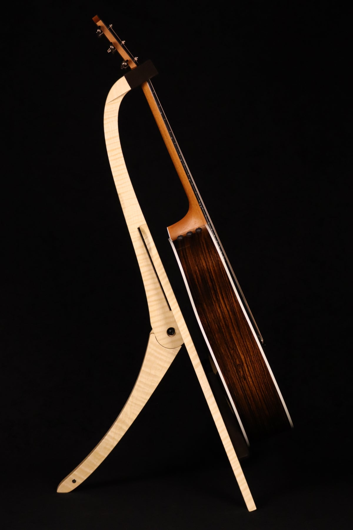 Folding curly maple wood guitar floor stand full side image with Taylor guitar