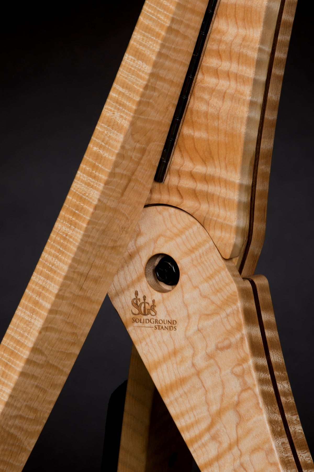 Folding curly maple and walnut wood guitar floor stand joinery detail image