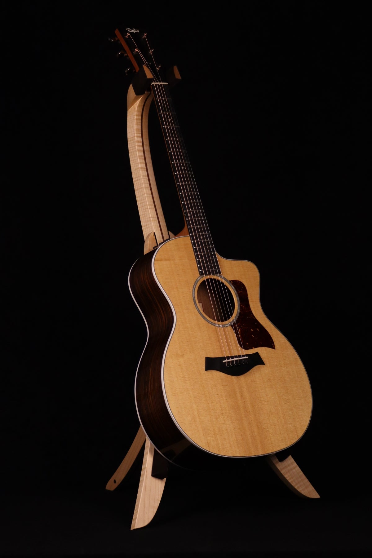 Folding curly maple and walnut wood guitar floor stand full front image with Taylor guitar