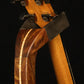 Folding chechen Caribbean rosewood and curly maple wood guitar floor stand yoke detail image with Taylor guitar