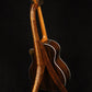 Folding chechen Caribbean rosewood and curly maple wood guitar floor stand full rear image with Taylor guitar