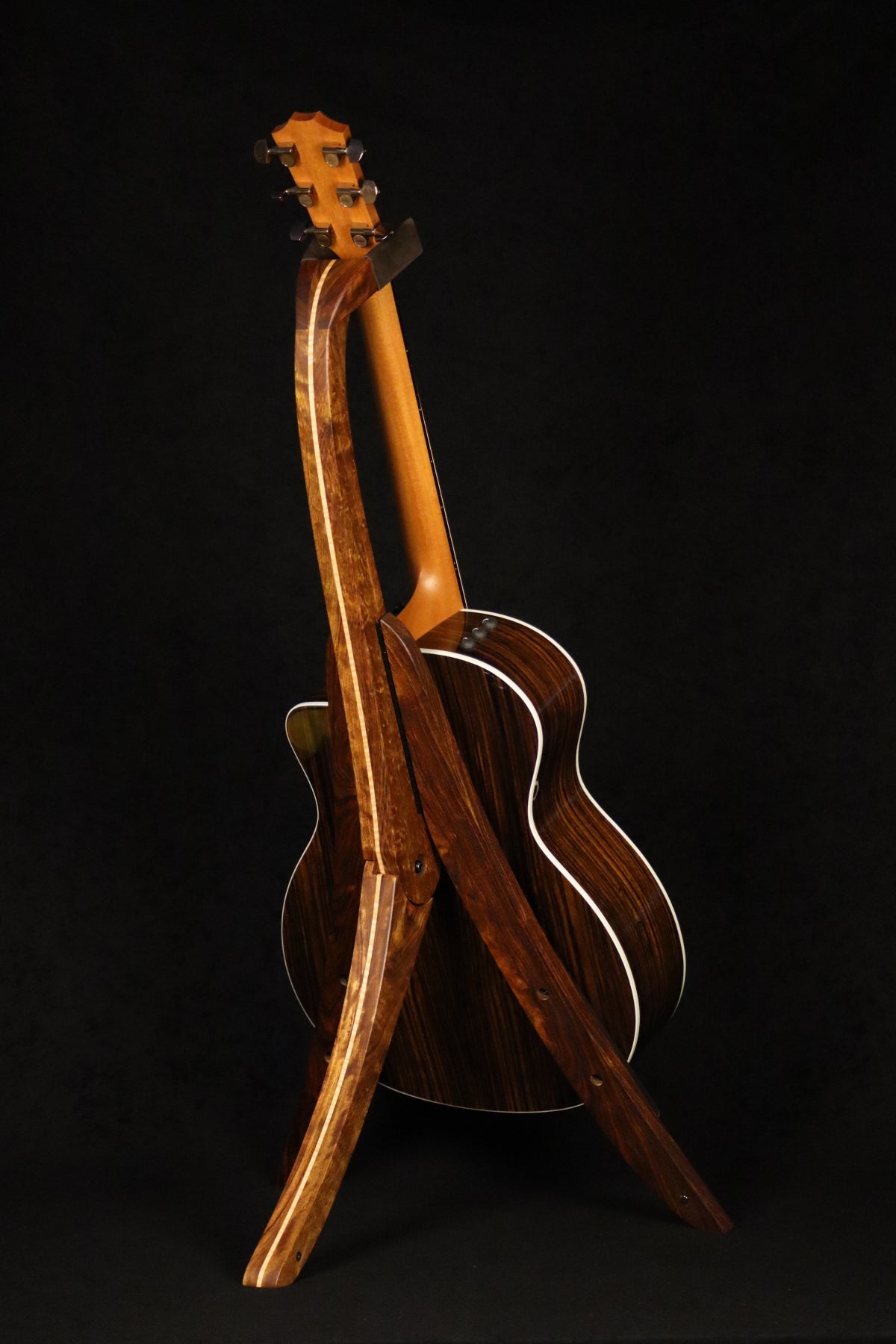 Folding chechen Caribbean rosewood and curly maple wood guitar floor stand full rear image with Taylor guitar