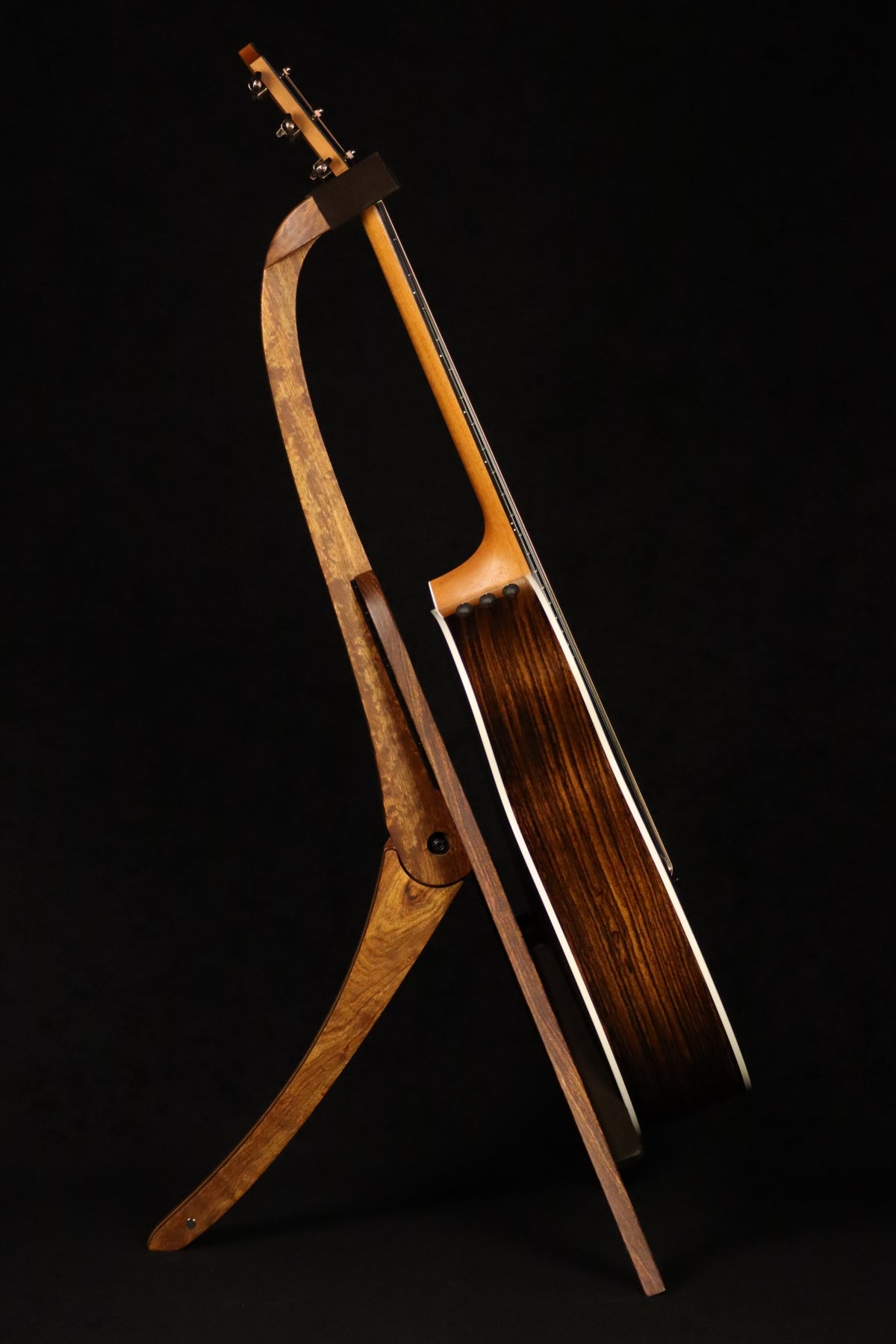 Folding chechen Caribbean rosewood and curly maple wood guitar floor stand full side image with Taylor guitar