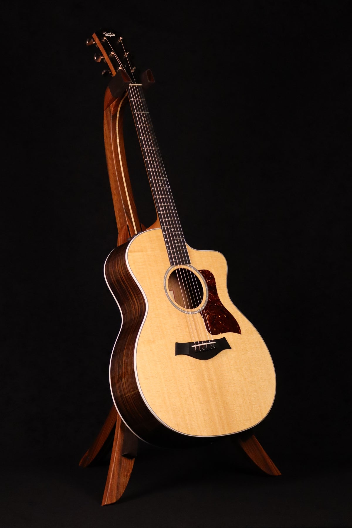 Folding morado Bolivian rosewood pau fero and curly maple wood guitar floor stand full front image with Taylor guitar