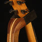 Folding sapele mahogany and curly maple wood guitar floor stand yoke detail image with Taylor guitar