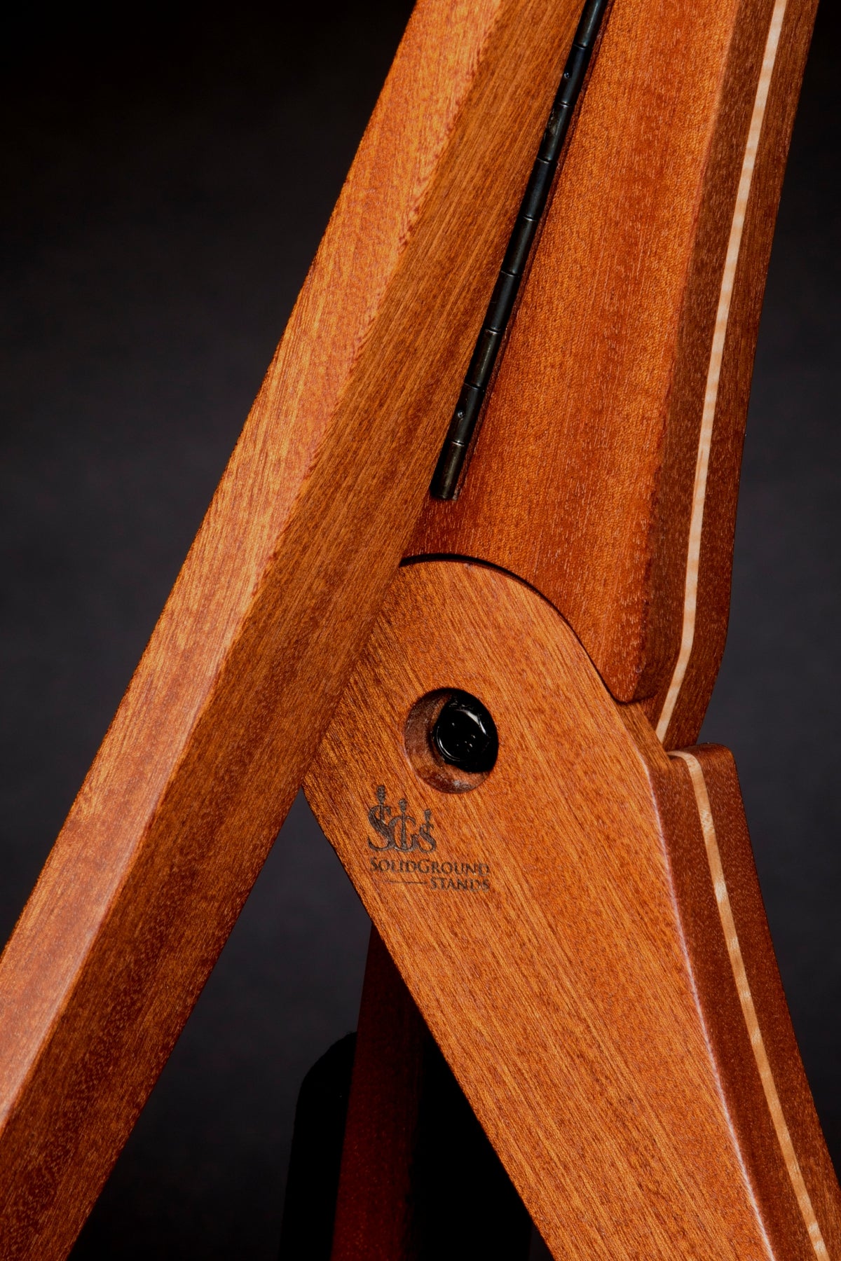 Folding sapele mahogany and curly maple wood guitar floor stand joinery detail image