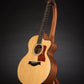 Folding sapele mahogany and curly maple wood guitar floor stand full front image with Taylor guitar