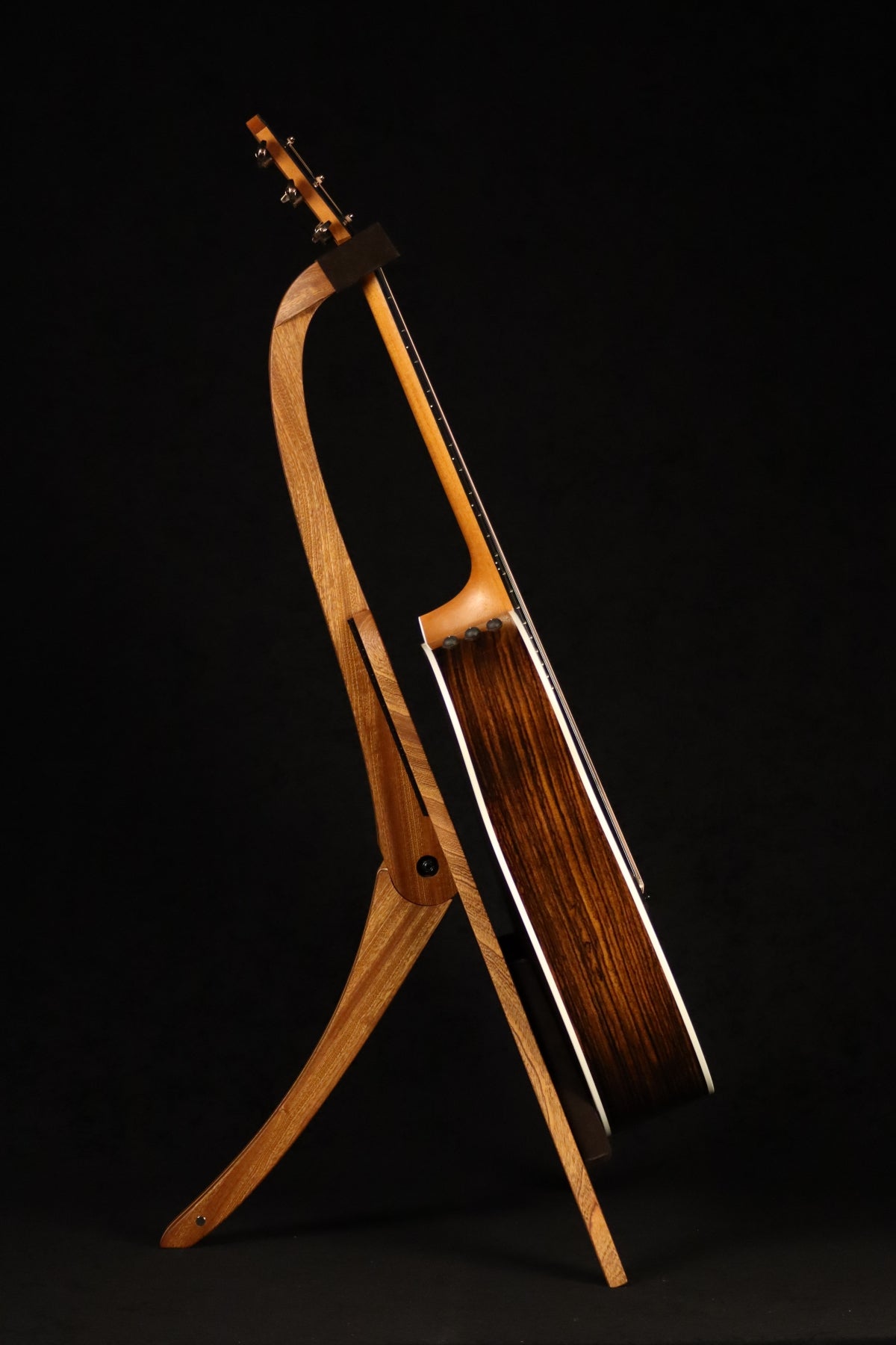 Folding sapele mahogany and curly maple wood guitar floor stand full side image with Taylor guitar