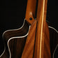 Folding sapele mahogany and curly maple wood guitar floor stand closeup rear image with Taylor guitar