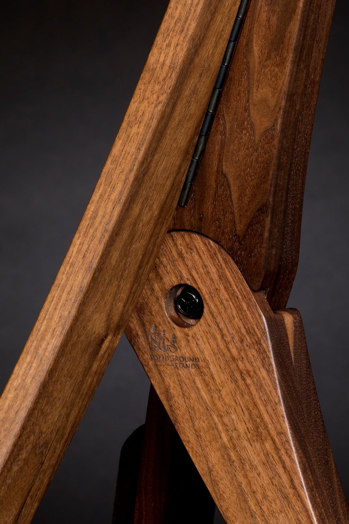 Folding walnut wood guitar floor stand joinery detail image