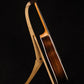 Folding walnut wood guitar floor stand full side image with Taylor guitar