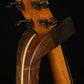Folding walnut and curly maple wood guitar floor stand yoke detail image with Taylor guitar